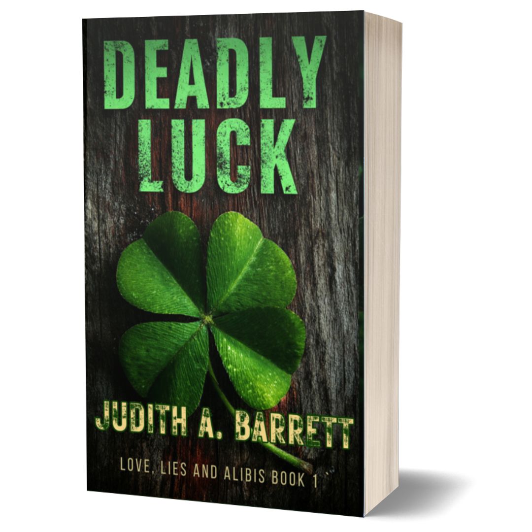 Book titled 'Deadly Luck' by Judith A. Barrett with a four-leaf clover on a wooden background.